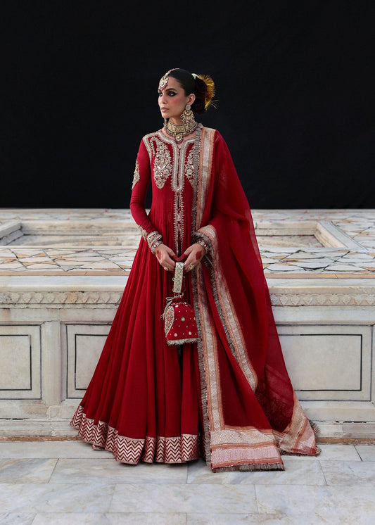 Model wearing Dilrubah by Hussain Rehar in deep red with gold embroidery – regal Pakistani luxury pret outfit in UK.
