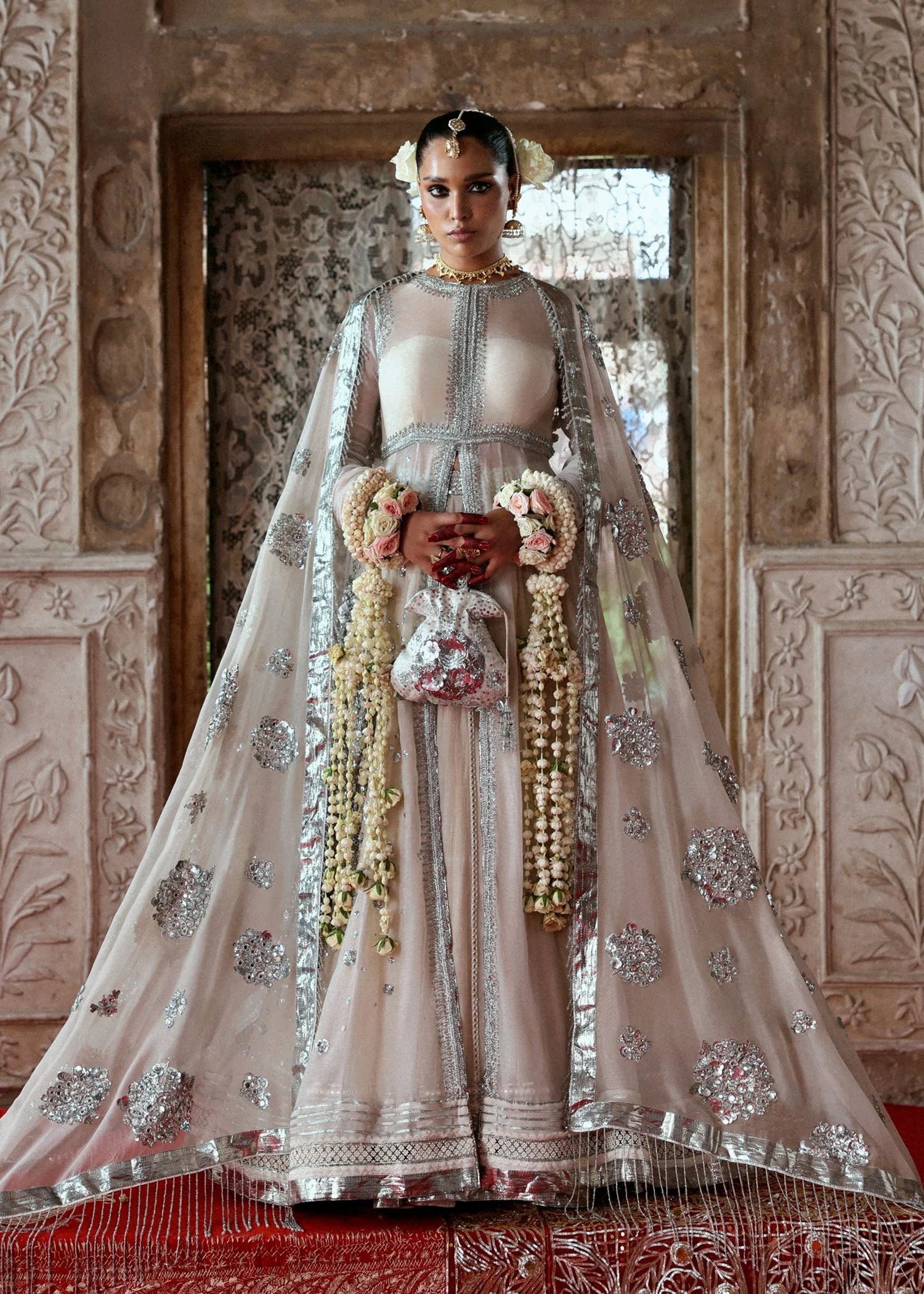 Model wearing Mina by Hussain Rehar in ivory with silver embellishments and cape – luxurious Pakistani luxury pret outfit in UK.