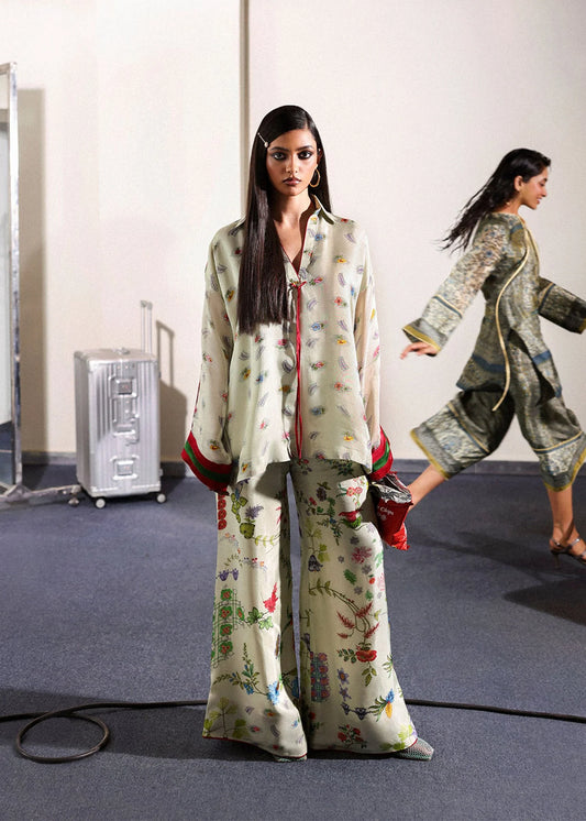 Model wearing ivory floral Mosselle outfit from Hussain Rehar featuring red and green cuff accents, ideal Pakistani luxury pret in UK.