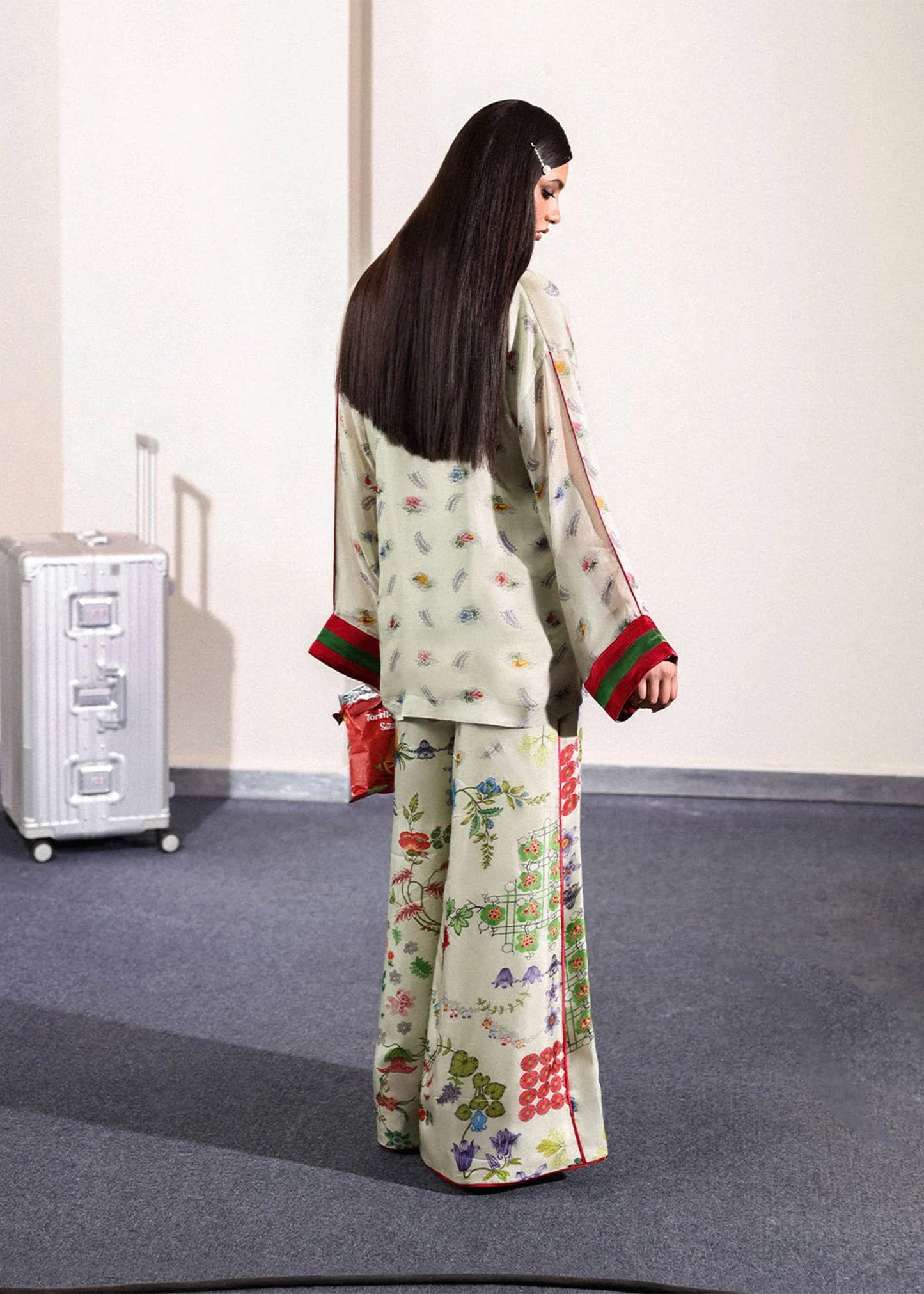 Model wearing ivory floral Mosselle outfit from Hussain Rehar featuring red and green cuff accents, ideal Pakistani luxury pret in UK.