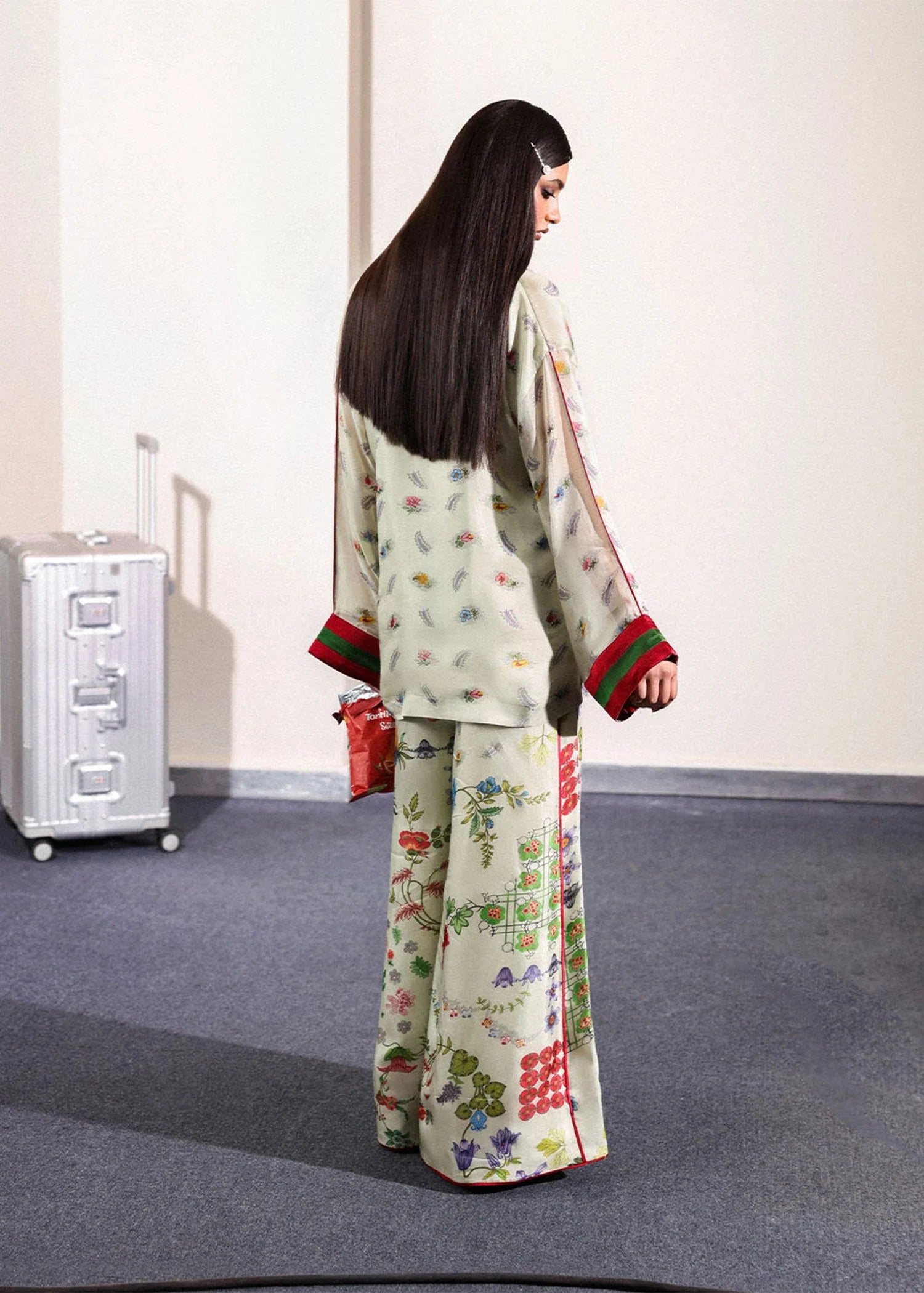 Model wearing ivory floral Mosselle outfit from Hussain Rehar featuring red and green cuff accents, ideal Pakistani luxury pret in UK.