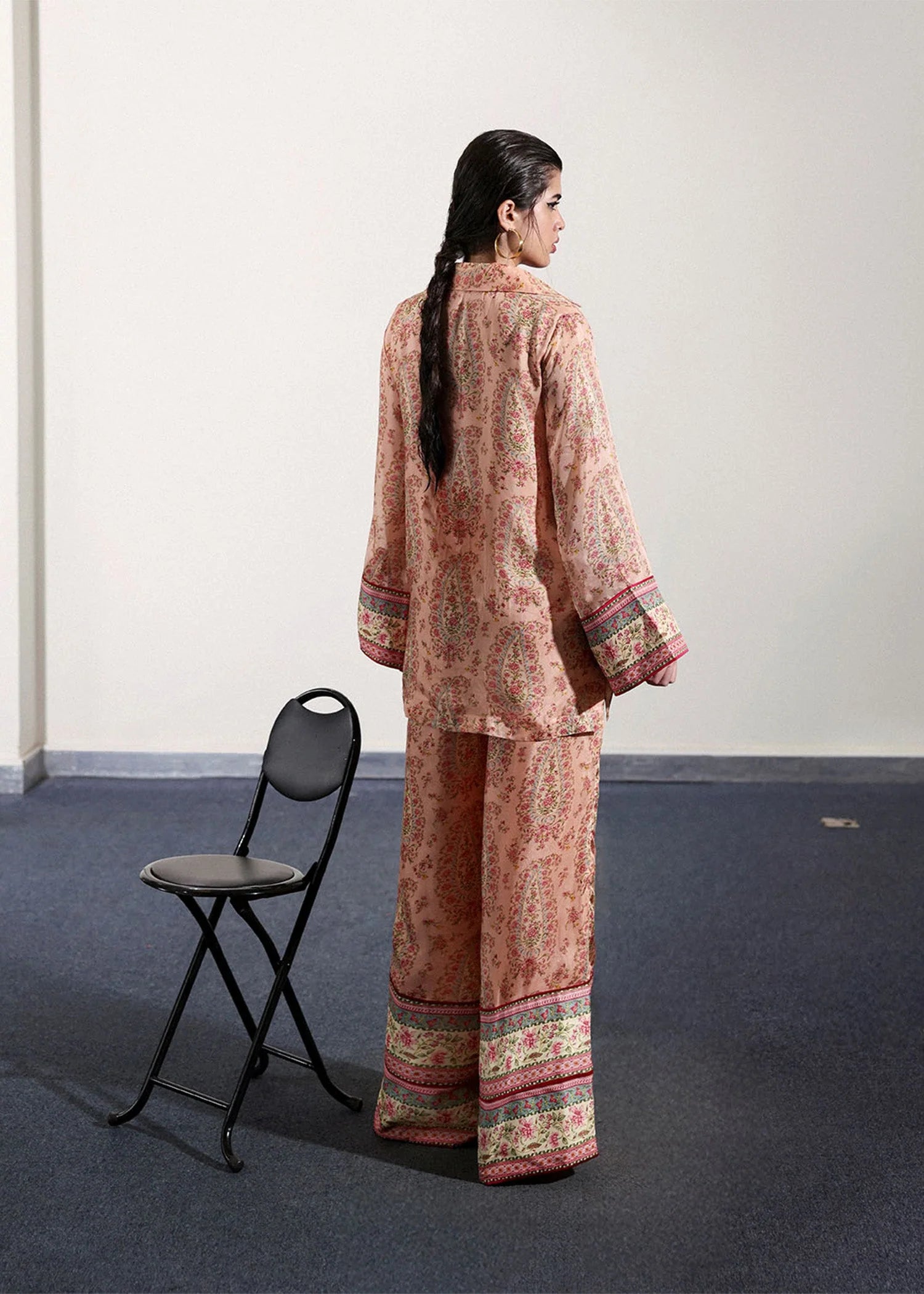 Model wearing peach and pink paisley printed outfit from Hussain Rehar, ideal for Pakistani luxury pret and clothes online in UK.