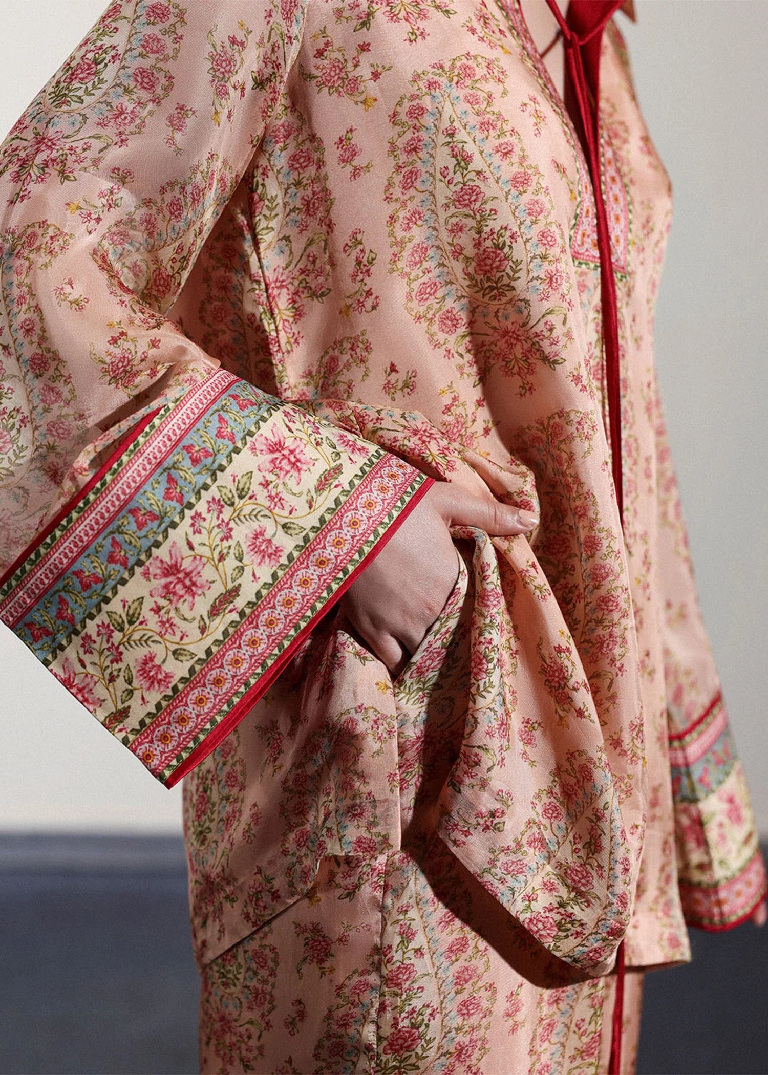 Model wearing peach and pink paisley printed outfit from Hussain Rehar, ideal for Pakistani luxury pret and clothes online in UK.
