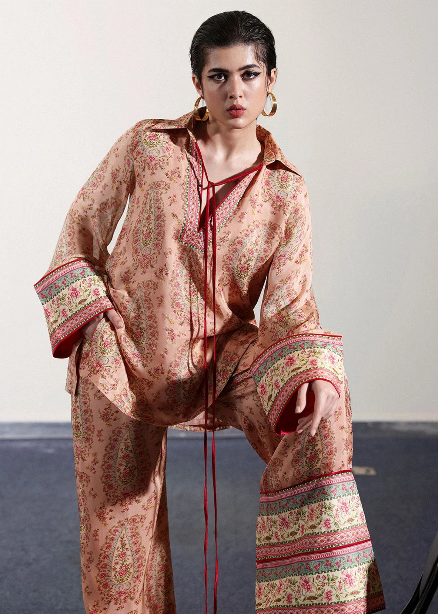 Model wearing peach and pink paisley printed outfit from Hussain Rehar, ideal for Pakistani luxury pret and clothes online in UK.